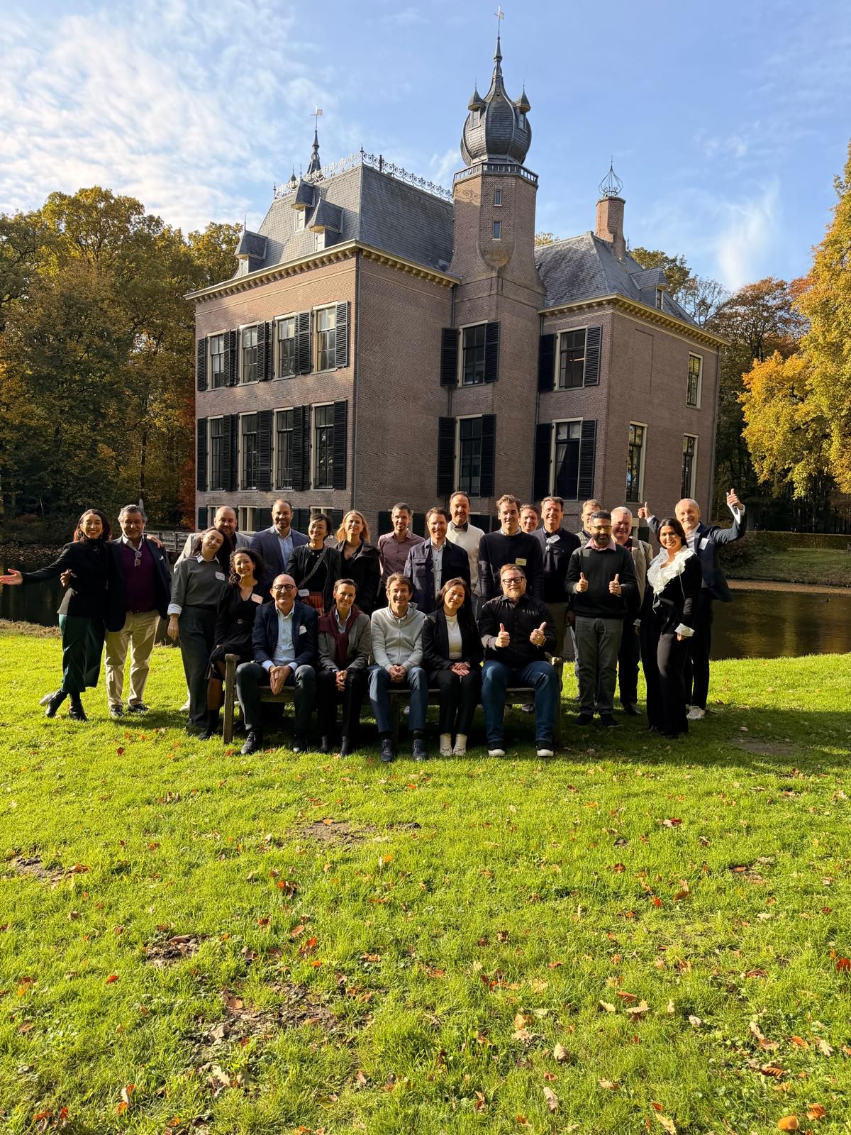 Group photo of founders, investors, leaders and board members Raja Skogland worked with, in front of a manor house