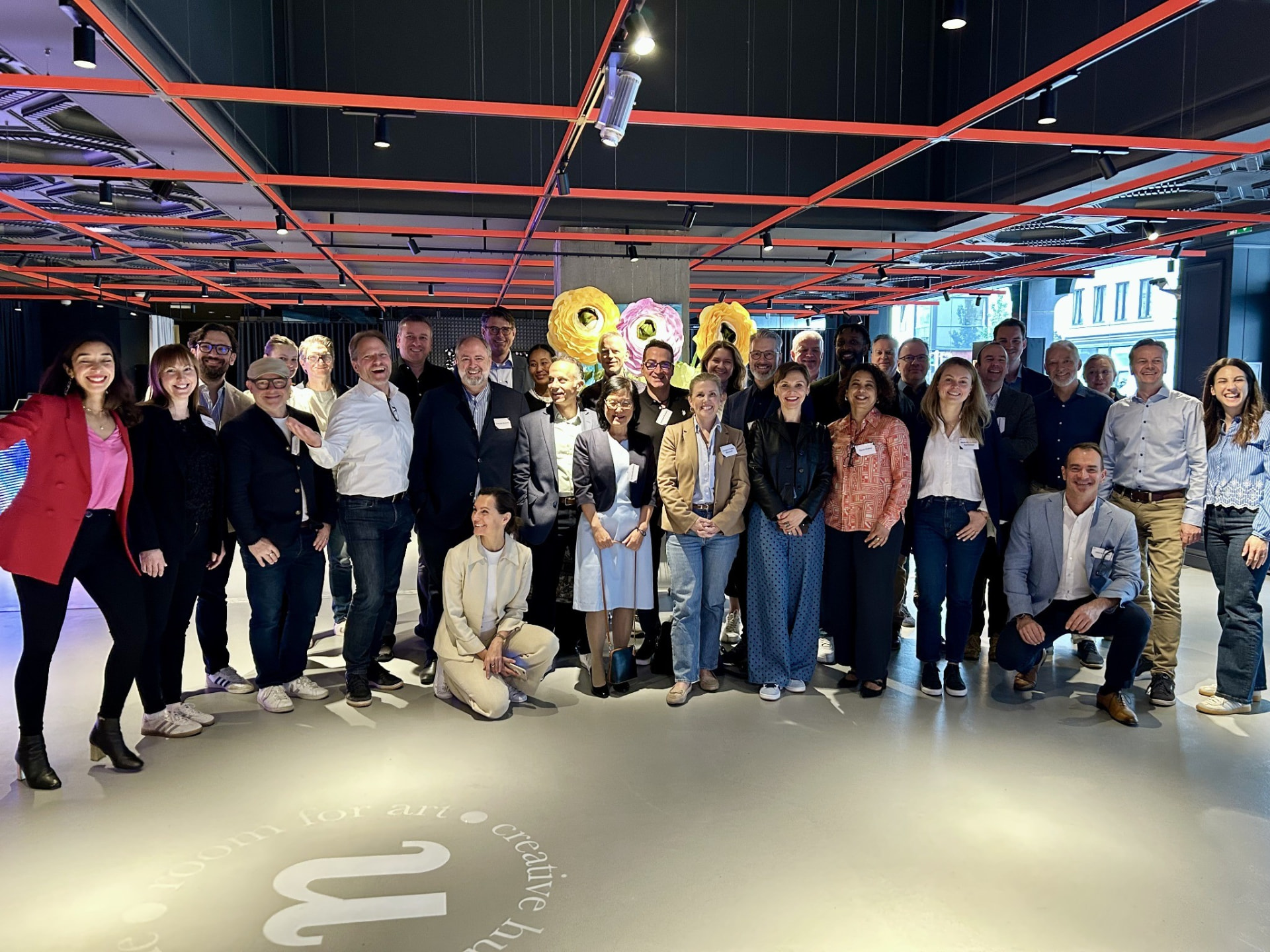 Group photo of a board programme cohort Raja Skogland worked with, at an indoor event space