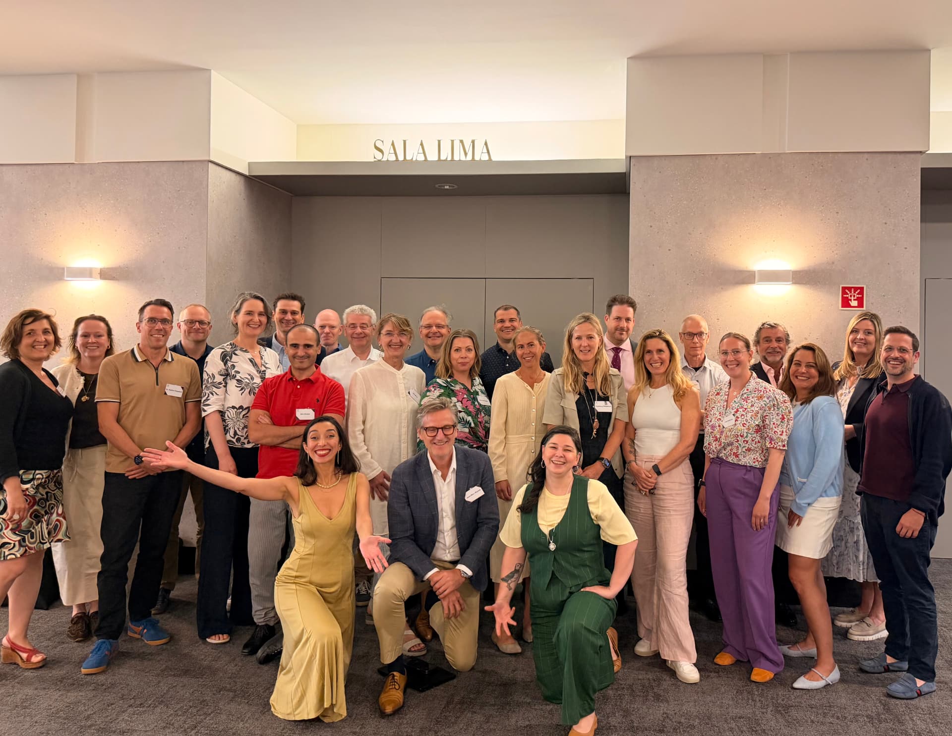 Group photo of leaders and investors Raja Skogland worked with, indoors